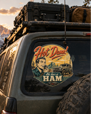 Suv with a humorous sticker on the back window in a mountainous landscape