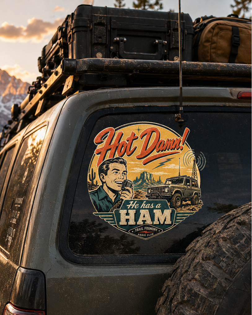 Suv with a humorous sticker on the back window in a mountainous landscape